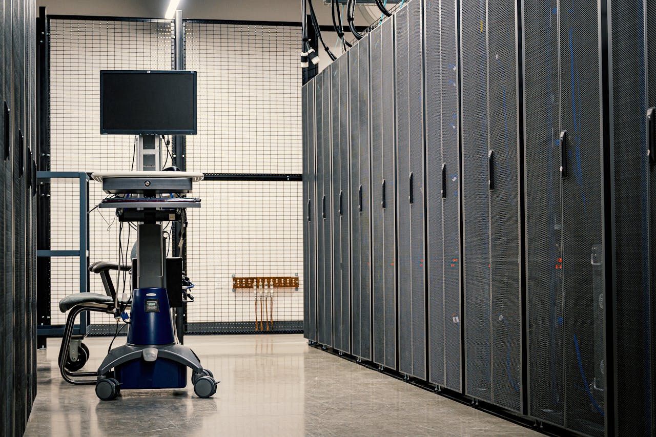 core-values Contemporary computer on support between telecommunication racks and cabinets in modern data center